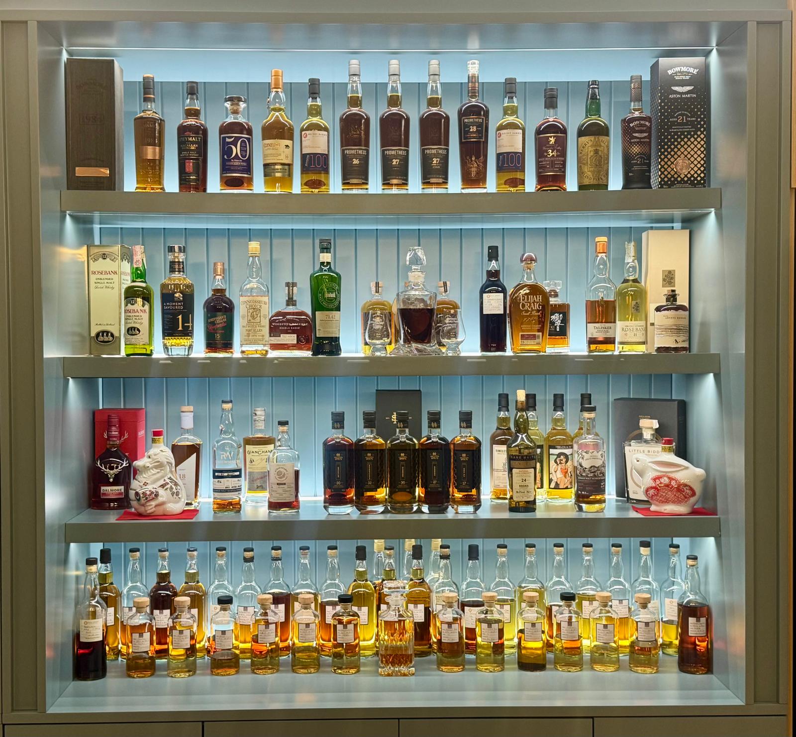 Illuminated Rare Whisky Holdings bottle display inside the Whisky Lounge